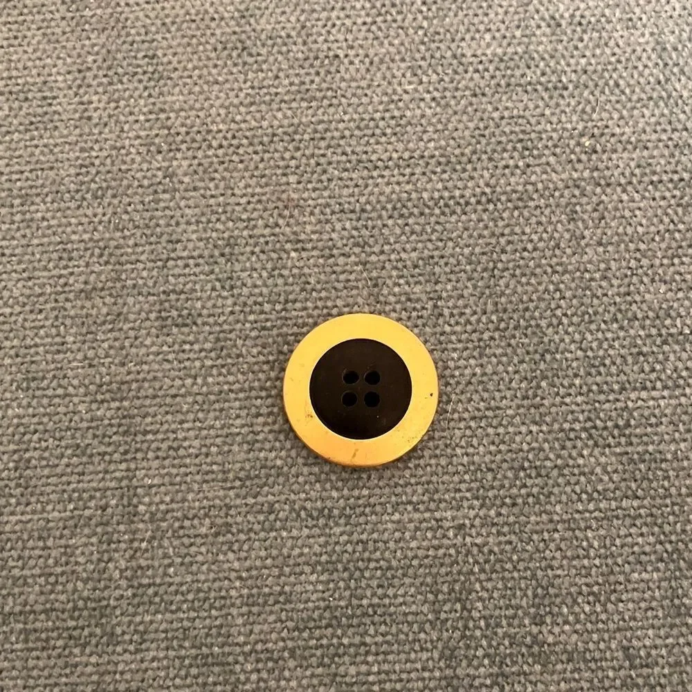 Black and Gold-Colored Button